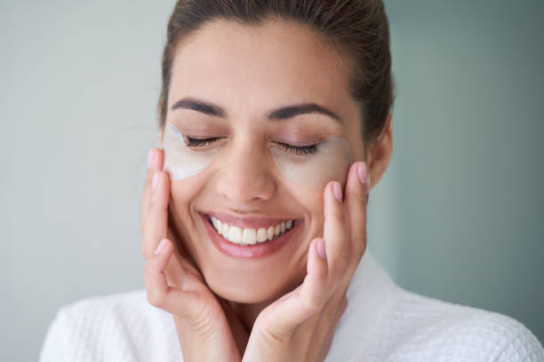 istock Delighted woman with under eye patches smiling 1268438729