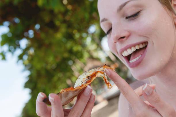 istock Beautiful women eating pizza 1268439122