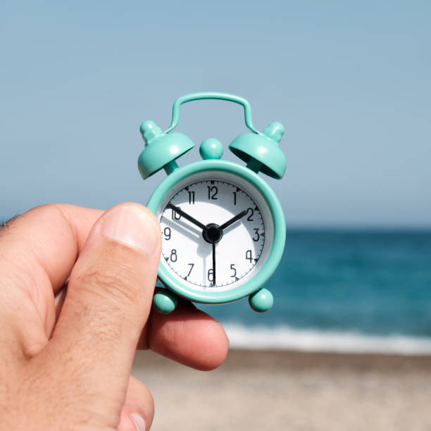 istock man with an alarm clock on the beach 1268439809