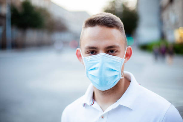 istock Men is wearing protective face mask during pandemic 1268440580