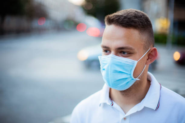 istock Men is wearing protective face mask during pandemic 1268441109