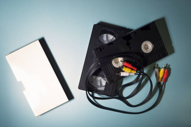 istock Retro VHS video tape and wires for video recorder. Top view. 1268441162
