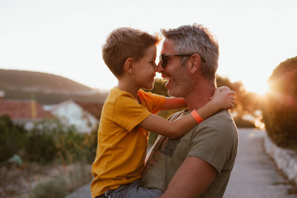 istock Father and son hugging outdoors, shallow depth of field 1268441899