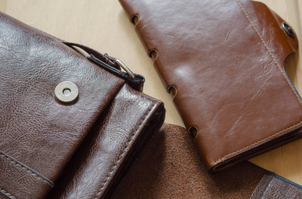 istock Small leather bag and wallet on wooden table. 1268445236