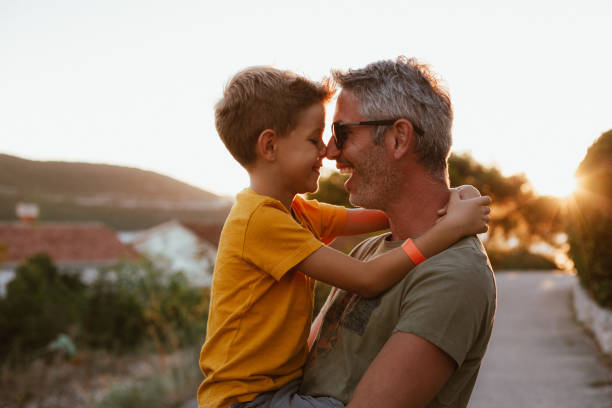 istock Father and son hugging outdoors, shallow depth of field 1268445455
