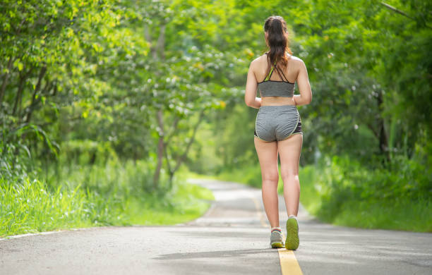 istock Young woman running outdoors. 1268448328