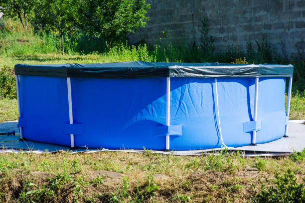 istock blue pool in the backyard of a private house. 1268449222