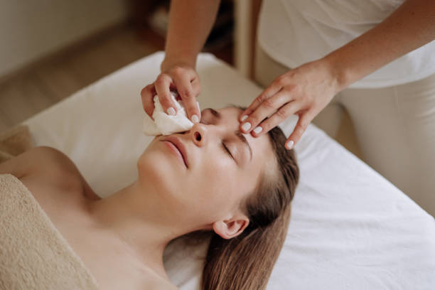 istock Cosmetologist Wiping Client Face after Massage 1268449443