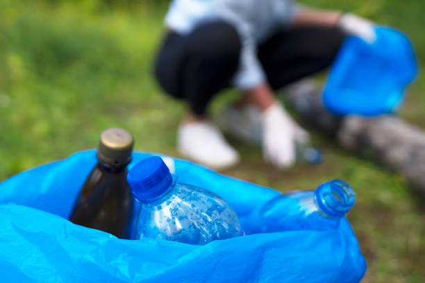istock Volunteer collecting bottles in the forest. Environment pollution concept. 1268449566