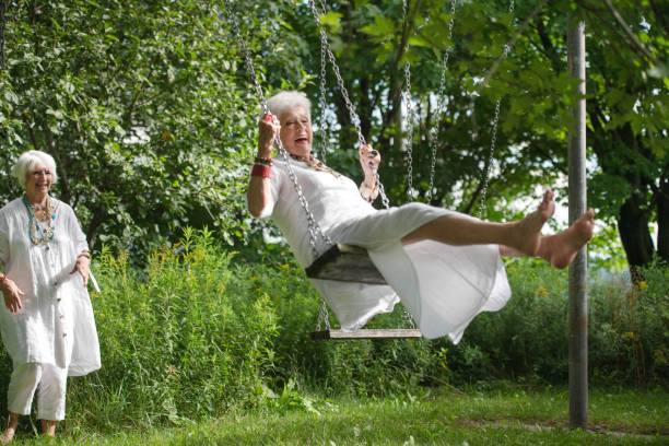 istock Senior best friend women on a swing 1268449702
