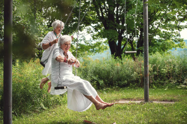 istock Senior best friend women on a swing 1268450492