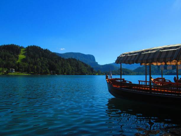 istock A boat floating on a blue lake. 1268451779