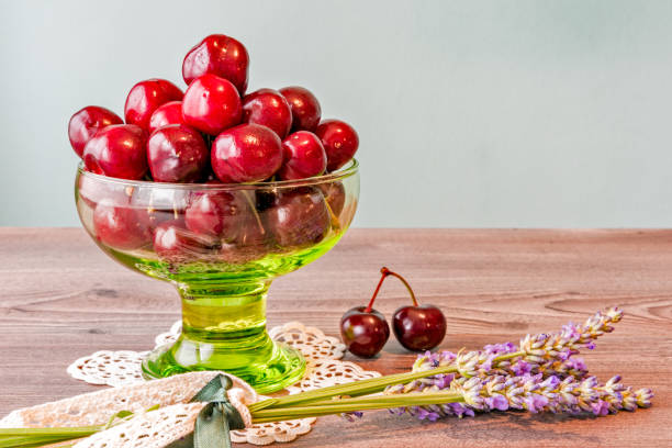 Fresh Picked Cherries in Green Bowl Standing on Wooden Table