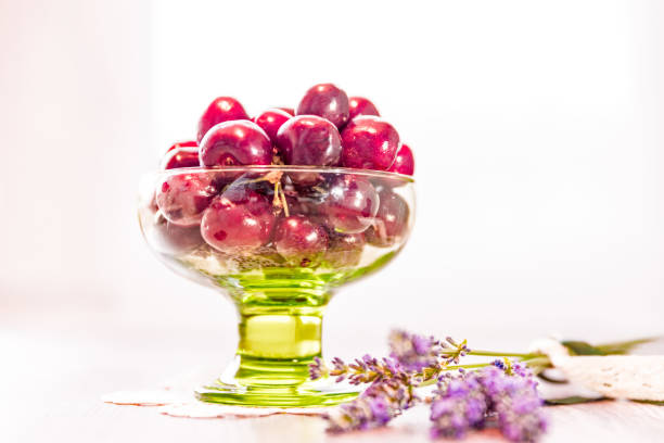 istock Fresh Picked Cherries in Green Bowl Standing on Wooden Table 1268454156