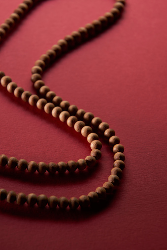 Buddhist reciting beads on red background