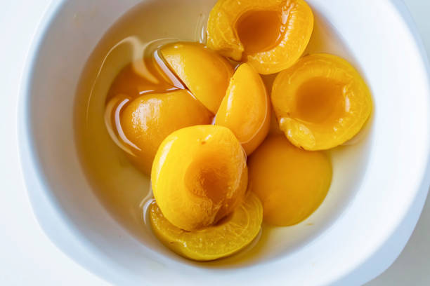 ready to eat apricot compote in a white bowl ready to eat apricot compote in a white bowl compote photos stock pictures, royalty-free photos & images