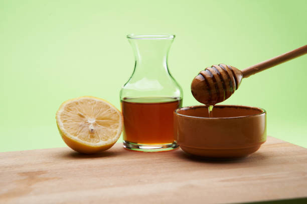 istock lemon and honey with dipper on the cutting board 1268460013