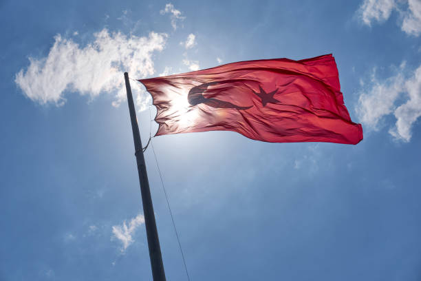 istock Turkish National Flag waving in the sky 1268462875