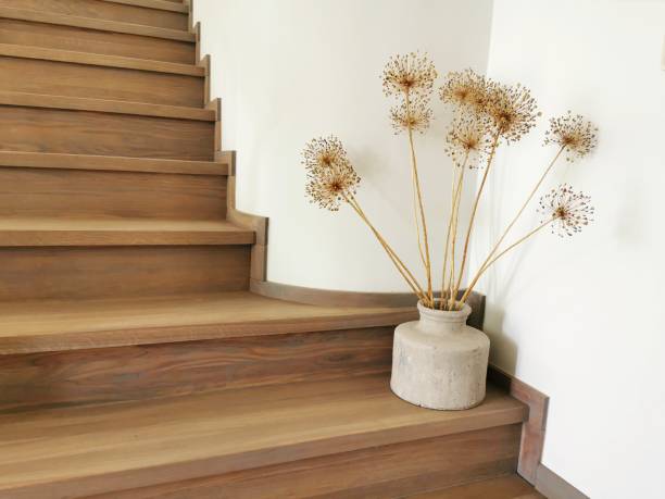 Vase with dried flowers on the stair. Home interior floristic decor.