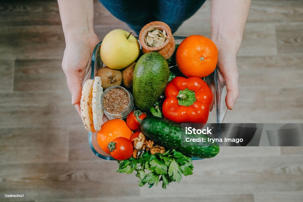 Functional foods, Health Super food concept very high in minerals, vitamins, antioxidants, omega 3. Various vegetables, fruits, nuts and seeds in woman hands Functional foods, Health Super food concept very high in minerals, vitamins, antioxidants, omega 3. Various vegetables, fruits, nuts and seeds in woman hands. Acid Stock Photo