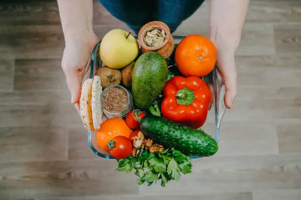 Photo of Functional foods, Health Super food concept very high in minerals, vitamins, antioxidants, omega 3. Various vegetables, fruits, nuts and seeds in woman hands