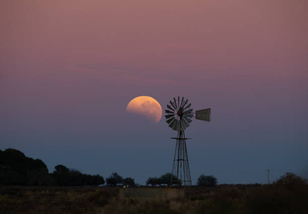 istock A blood moon sets behind a silhouette of a windpomp 1268464520