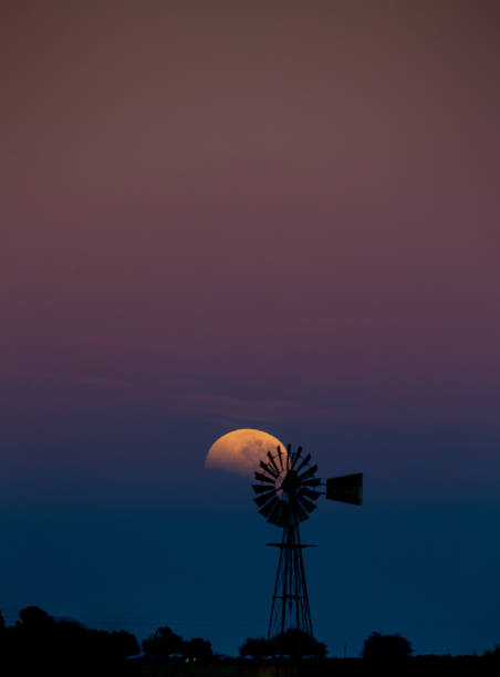 istock A blood moon sets behind a silhouette of a windpomp 1268464550