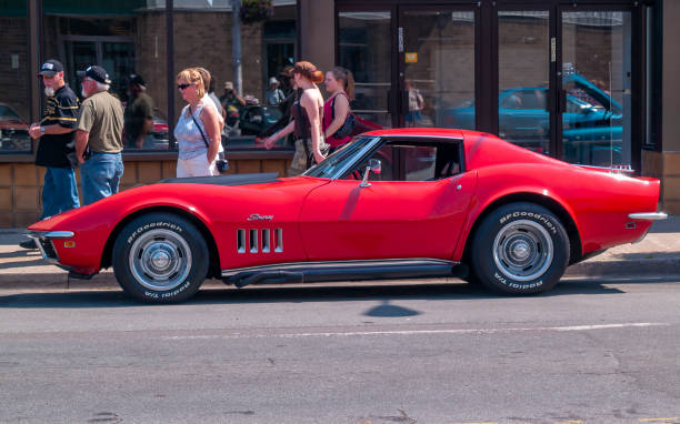 1969 Chevrolet Corvette Stingray Halifax, Nova Scotia, Canada - July 19, 2009 : 1969 Chevrolet Corvette Stingray at Cars on Quinpool Road Car Show, Halifax, Nova Scotia, Canada. People walk on the sidewalk near the vintage car. 2009 stock pictures, royalty-free photos & images