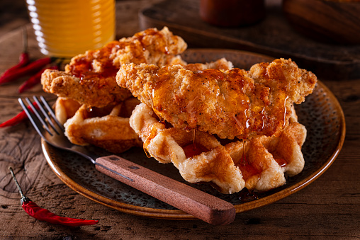 Delicious fried chicken and waffles with spicy hot honey sauce.