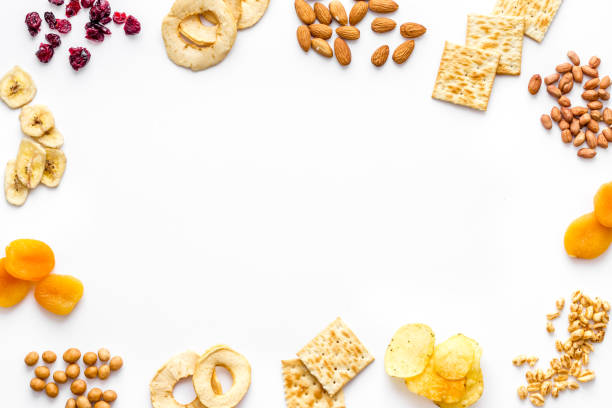 Snacks mix frame top view. Nuts and dried fruits with crackers, copy space.