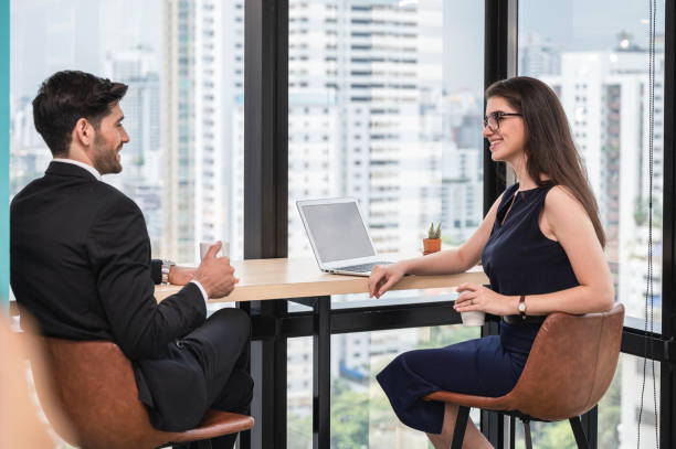 istock Young caucasian business partner discussing on desk corner in office 1268469113