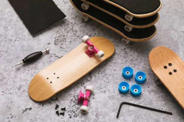 Photo of Disassembled fingerboard and various accessories on the table with repair tools