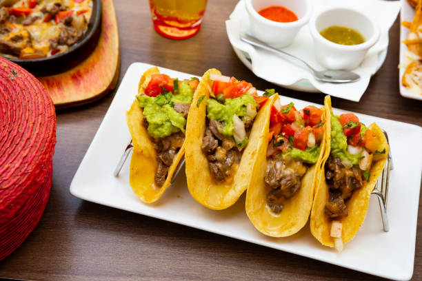 istock Mexican tacos with beef, guacamole and vegetables 1268469242