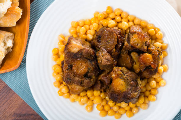 istock Braised oxtails with chickpeas on a white plate 1268469369