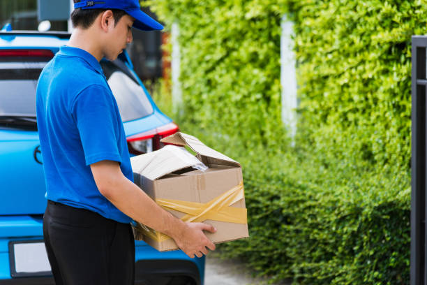 istock Delivery man he emotional courier hold damaged cardboard box is broken 1268469495