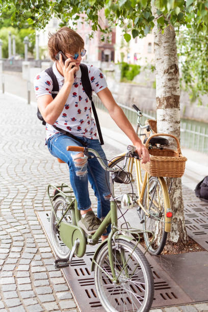 istock Young student sitting on a bicycle in town 1268470916
