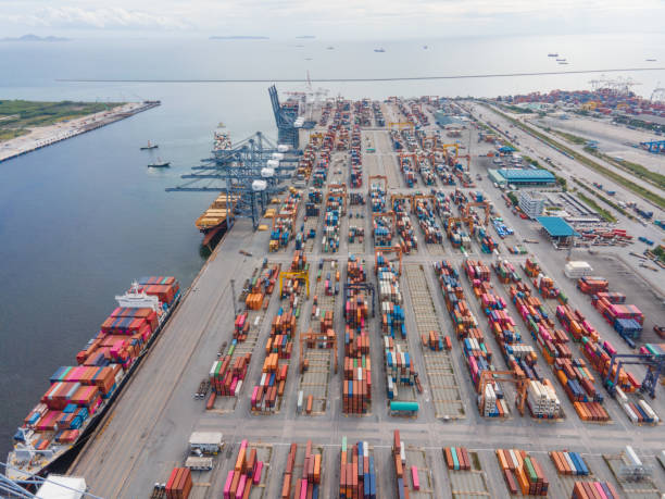 istock Drone shot of Shipiping harhor logistics and transportation for e-commerce Cargo ship  with working crane bridge in shipyard concept import export industry background 1268471608