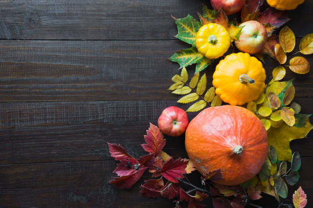 istock Frame of pumpkin and maple leaves on wooden board. Fall. Top view. Copy space. 1268472646