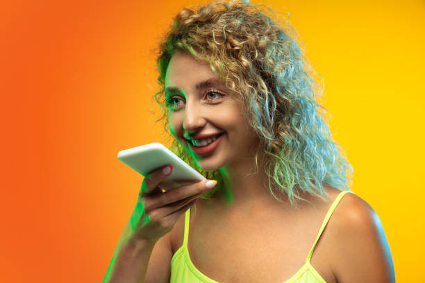 istock Caucasian young woman's portrait on gradient studio background in neon 1268472677
