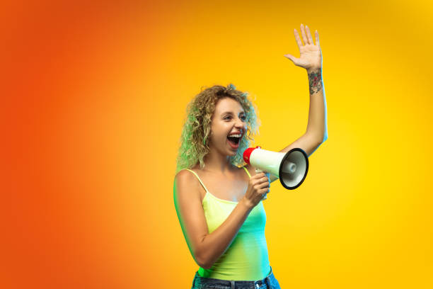 istock Caucasian young woman's portrait on gradient studio background in neon 1268472680