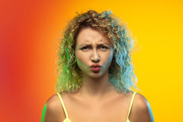 istock Caucasian young woman's portrait on gradient studio background in neon 1268472702