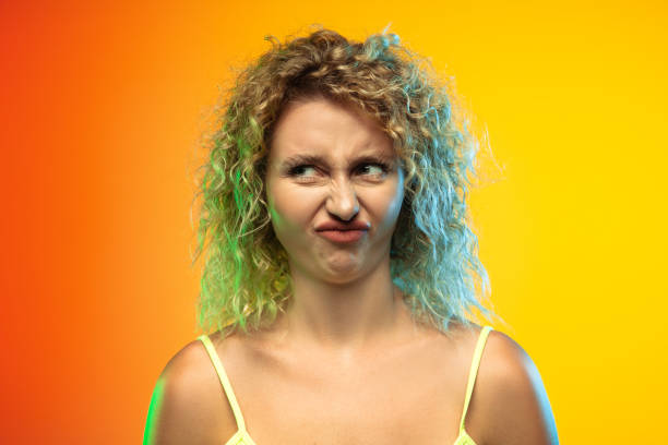istock Caucasian young woman's portrait on gradient studio background in neon 1268472711