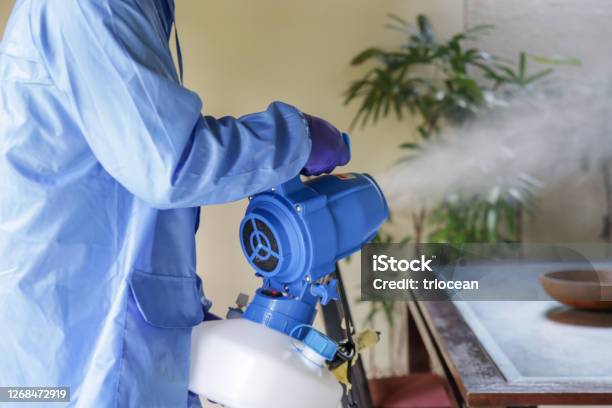 Cleaning And Disinfecting Key Weapons In The Fight Against Contagious Diseases Spray Disinfection Of Surfaces In The House Fogging With Disinfectant Due To Coronavirus Stock Photo - Download Image Now