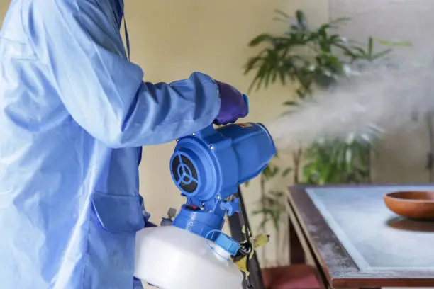 Photo of Cleaning and disinfecting: Key weapons in the fight against contagious diseases. Spray disinfection of surfaces in the house. Fogging with disinfectant due to coronavirus.