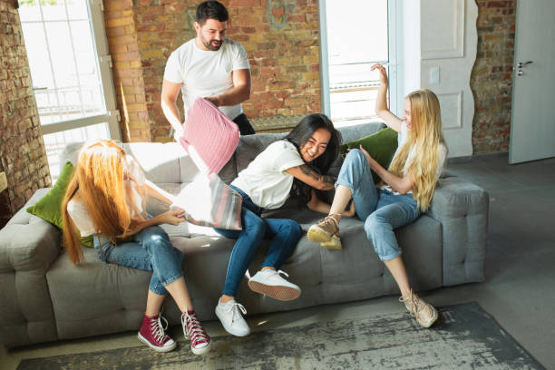 istock Group of adorable multiethnic friends having fun at home interior background 1268474809