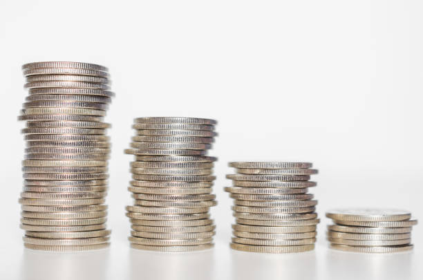 istock silver coin stack row growing pile on white background for money saving and investment business financial and banking concept. 1268476501