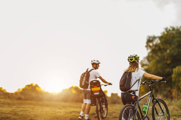 istock Happy young family with bicycles in park 1268477748