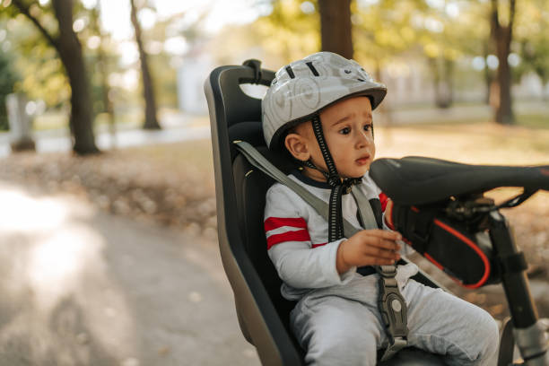 istock Cute little boy in bicycle safety seat 1268477820