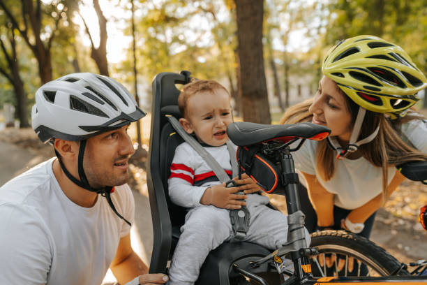 istock Happy young family with bicycles in park 1268477875