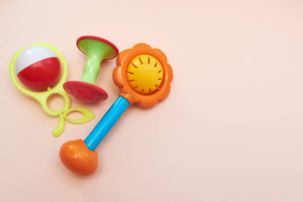 istock Plastic Retro Rattle. Baby toys on pink background. Flat lay. Copy space. 1268481238